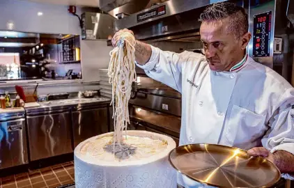  ?? ?? Three One Four executive chef Mario Vollera serves cacio e pepe pasta tossed in a cheese wheel.