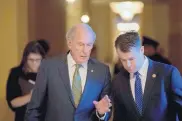  ?? ANDREW HARNIK/ASSOCIATED PRESS ?? Former Sen. Dan Coats, R-Ind., left, speaks with Sen.elect Todd Young, R-Ind., right, as they leave a meeting on Capitol Hill in Washington in 2016.