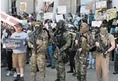  ?? MICHAEL DWYER/AP ?? People, including some in the “boogaloo” movement, demonstrat­e May 2 in Concord, New Hampshire.