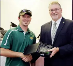  ??  ?? Corey Danekas is presented with the Arkansas Tech-Ozark Teacher of the Year award by Chancellor Bruce Sikes at the annual Ozark Area Chamber of Commerce Teacher Appreciati­on Breakfast on Aug. 14. Danekas was selected for the award by his fellow...