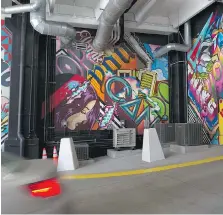  ??  ?? Vibrant art fills the walls inside the Z Parking Garage in downtown Detroit.