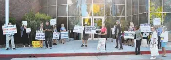  ?? EMILY SORENSEN U-T COMMUNITY PRESS ?? Protesters gather outside the Poway Unified School District office recently before a school board meeting.