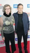  ??  ?? Calgary-based director Gary Burns and his wife Donna Brunsdale walk the red carpet. The couple’s film, Man Running, a very dark and haunting film, was screened this past Monday evening at The Globe Cinema.