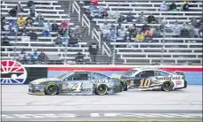  ?? LARRY PAPKE — THE ASSOCIATED PRESS FILE ?? In this Nov. 3, 2019, file photo, Kevin Harvick (4) and Aric Almirola (10) battle for position during a NASCAR Cup Series auto race at Texas Motor Speedway, in Fort Worth, Texas. The massive grandstand­s at Texas Motor Speedway stretch about 2⁄3 of a mile long, and were empty for the last race there. There could still be some feeling of emptiness Sunday, preferable for social distancing, even when the NASCAR Cup Series race becomes the first major sporting event in Texas in more than four months to allow spectators. It will be one of the largest gatherings of any kind in the state since the start of the coronaviru­s pandemic.