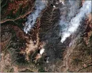  ?? DIGITALGLO­BE ?? This June 9 satellite image shows the 416 Fire (right) and the Burro Fire (left), northwest of Durango, Colo. San JuanNation­al Forest officials in southweste­rn Colorado closed trails and miles of back roads Tuesday.