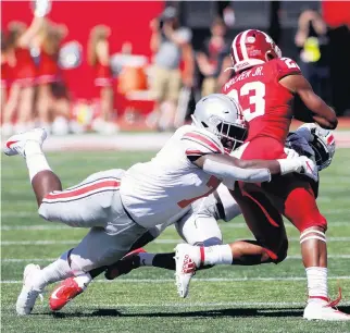  ?? JUSTIN CASTERLINE/GETTY IMAGES FILE ?? Teradja Mitchell tackles Ronnie Walker Jr. during the second quarter on Sept. 14, 2019, in Bloomingto­n, Indiana. Mitchell remained with Ohio State, but Walker, who grew up in Hopewell, transferre­d from Indiana to Virginia.