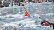  ?? REUTERS ?? Protesters hold up plastic sheets to protect themselves from a possible firing of water cannons in Yangon on Tuesday.