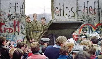  ??  ?? Breakthrou­gh: East German guards open a section of the Berlin Wall on November 11, 1989