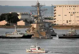 ?? —REUTERS ?? Tugboats tow the USS Fitzgerald upon its arrival at the US naval base in Yokosuka, Japan.