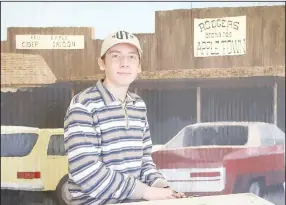  ?? ?? Artist Jonathan Fox sits in front of mural he painted of the front of the new appleton Store building in Lincoln. Jonathan also helps his mother, Levicy Fox, who is using a separate space at appletown Store for her Fox in the Henhouse bakery.