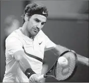  ?? Paul Buck EPA-EFE/REX/Shuttersto­ck ?? ROGER FEDERER strokes a backhand during a 7-5, 6-1 win over Hyeon Chung of South Korea.