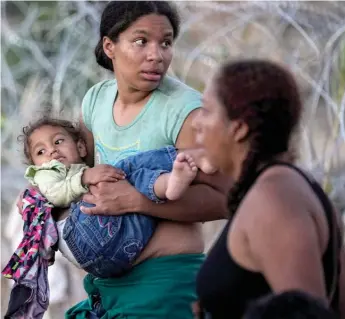  ?? ERIC GAY/AP FILE ?? Migrants cross the Rio Grande and enter the U.S. to be processed by U.S. Customs and Border Protection in September 2023 in Eagle Pass, Texas.