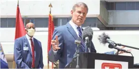  ?? BRETT KELMAN/THE TENNESSEAN ?? Gov. Bill Lee speaks at an unveiling ceremony of an emergency coronaviru­s ward at Nashville General Hospital on June 5. Hospital CEO Joseph Webb listens in the background.