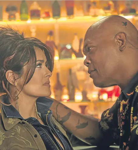  ??  ?? Salma Hayek, pictured above with Samuel L Jackson, delivers a stand-out performanc­e in The Hitman’s Bodyguard.