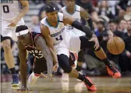  ?? NATHAN DENETTE — THE CANADIAN PRESS VIA AP ?? Toronto Raptors forward Pascal Siakam (43) and Charlotte Hornets guard Devonte’ Graham (4) vie for control of the ball during second-half NBA basketball game action in Toronto, Friday, Feb. 28, 2020.