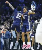  ?? AP photo ?? Jaylen Murray (left) and Latrell Reid celebrate after 15th-seeded Saint Peter’s defeated No. 3 Purdue 6764 on Friday in the NCAA Tournament regionals semifinals.