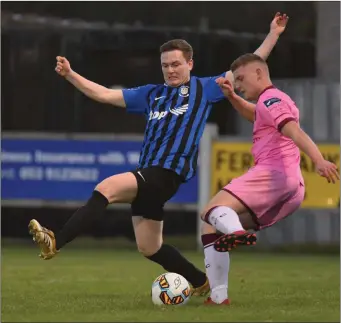  ??  ?? Mark Slater in control of the ball as Ian Fletcher of Athlone Town narrows the angle.