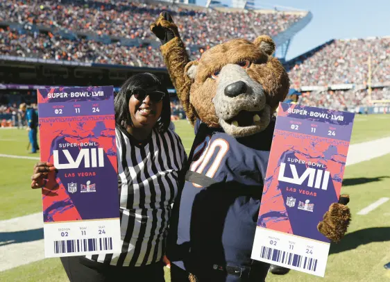  ?? ?? The Bears chose Markham resident Shameka Leach as its nominee for 2023 NFL Fan of the Year, surprising her at halftime of a game against the Las Vegas Raiders when Leach thought she was attending as a “guest referee” of a contest between Bears mascot Staley and the mascot of the Raiders. CHICAGO BEARS PHOTOS