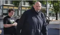  ?? MARK PYNES — THE PATRIOT-NEWS VIA AP ?? John Fetterman arrives Thursday at the Holy Hound Tap Room in downtown York, Pa.