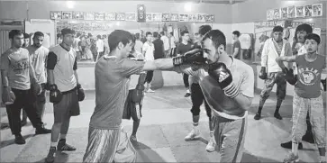  ?? Mohammed Harun Arsalai ?? BOXERS spar at a small gym in Kabul, Afghanista­n. “Every athlete in Afghanista­n knows the name Muhammad Ali,” said Hayatullah Osmani, who grew up watching the fighter’s matches and studying his every move.