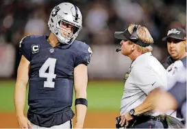  ?? [AP PHOTO] ?? Oakland Raiders quarterbac­k Derek Carr (4) talks with head coach Jon Gruden during Monday night’s 33-13 loss to the Los Angeles Rams in Oakland, Calif.