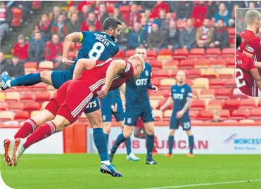  ??  ?? Curtis Main heads home to open the scoring for a dominant Aberdeen at Pittodrie . . .