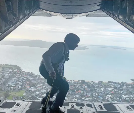  ??  ?? Defence Minister Ron Mark performs a move ripped from the playbook of Hollywood star Tom Cruise (below) in the skies above Auckland yesterday.