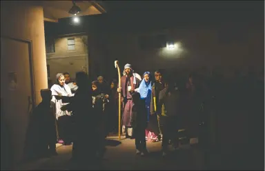  ?? NEWS-SENTINEL PHOTOGRAPH­S BY BEA AHBECK ?? Joseph, played by Florentino Lopez, and Maria, played by Katrina Barcenas, walk in search of lodging during St. Anne’s Catholic Church’s Las Posadas celebratio­n in Lodi on Wednesday. The traditiona­l Mexican Christmas celebratio­n reenacts Mary and...