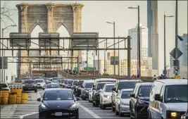  ?? BEBETO MATTHEWS — THE ASSOCIATED PRESS FILE ?? Traffic enters lower Manhattan in New York after crossing the Brooklyn Bridge on Feb. 8.