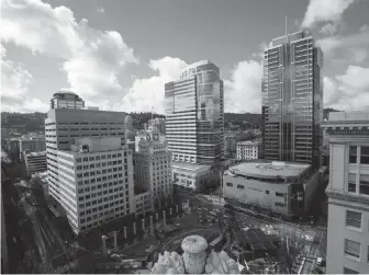  ??  ?? Downtown Portland, seen from the roof of the Meier and Frank Building. At bottom of frame is Pioneer Courthouse Square.