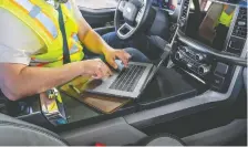  ??  ?? A fold-out platform can serve as a desk in the 2021 Ford F-150. Ford says a third of F-150 owners use a laptop in their trucks.