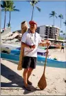  ?? ?? FAR RIGHT: Indigenous artist Akac Orat stands with his paddle in Hawaii last week during the Queen Lili’uokalani Canoe Race.