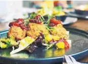  ?? DELANEY’S TAVERN ?? Chef Anthony Albino pairs the salmon fritters at Delaney’s Tavern with a jicama salad and pepper-tomato jam.