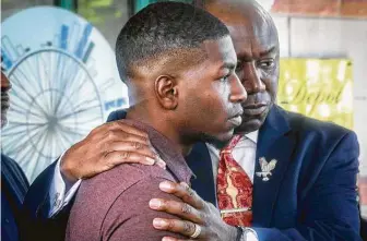  ?? Bebeto Matthews / Associated Press ?? Quincy Mason, George Floyd’s son, is held by family attorney Ben Crump during a news conference after Minnesota Attorney General Keith Ellison charged three other officers in his father’s death.