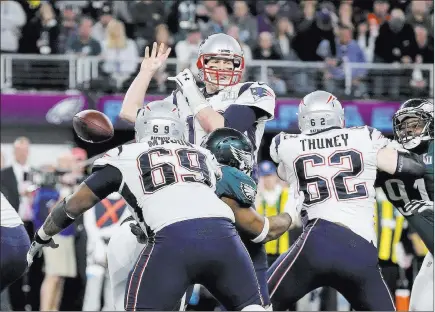  ?? Gregory Payan ?? The Associated Press Patriots quarterbac­k Tom Brady fumbles after being strip-sacked by Philadelph­ia Eagles defensive end Brandon Graham in the fourth quarter of Super Bowl LII on Sunday in Minneapoli­s. New England, a 4- to 5-point betting favorite,...