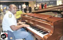  ?? PICTURE: THOKOZANI MBUNDA/AFRICAN NEWS AGENCY (ANA) ?? STRIKING A CHORD: Sergeant Sizwe Khalala hits the keys of a piano at King Shaka Internatio­nal Airport’s domestic arrivals hall, impressing passengers and waiting people.