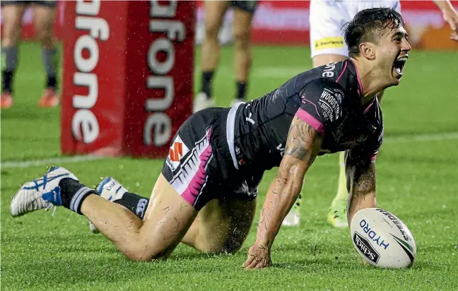  ?? PHOTO: PHOTOSPORT ?? Shaun Johnson celebrates his matchwinni­ng try in golden-point time that gave the Warriors victory over the Panthers in Auckland on Saturday.