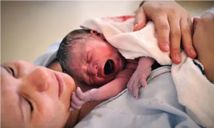  ??  ?? A newborn baby with his mother moments after birth. Photograph: Lionel Wotton/Alamy