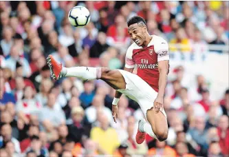  ?? MICHAEL REGAN GETTY IMAGES ?? Pierre-Emerick Aubameyang of Arsenal controls the ball during a Premier League soccer match against Manchester City at Emirates Stadium in London on Sunday.