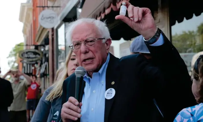  ??  ?? Bernie Sanders holds up a vial of insulin during a rally outside a pharmacy in Windsor, Ontario. Photograph: Rebecca Cook/Reuters