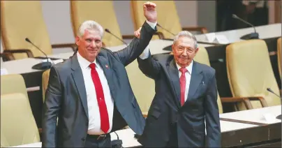  ?? AP PHOTO ?? Cuba’s new president Miguel Diaz-Canel, left, and former president Raul Castro, raise their arms after Diaz-Canel was elected as the island nation’s new president, at the National Assembly in Havana, Cuba, Thursday.