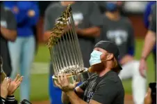  ?? AP FILE PHOTO/ERIC GAY ?? In this Oct. 27 file photo, Los Angeles Dodgers third baseman Justin Turner celebrates with the trophy after defeating the Tampa Bay Rays 3-1 to win the baseball World Series in Game 6 in Arlington, Texas.
