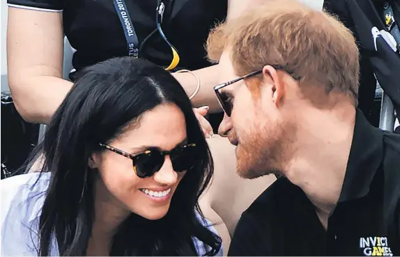  ?? AP ?? Prince Harry and his girlfriend Meghan Markle made their first public appearance as a couple at the Invictus Games.