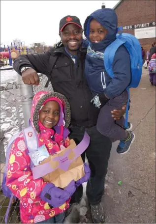  ?? CATHIE COWARD, THE HAMILTON SPECTATOR ?? Benjamin Oscar and his children, Jacque and Danielle, are happy with Hess Street School. That’s why Oscar’s family is fighting to keep it open. The school has a lot of new Canadian students. The Oscar family is from Congo.