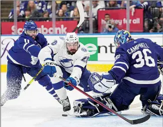  ?? ?? Tampa Bay Lightning left wing Nicholas Paul (20) falls toward Toronto Maple Leafs goaltender Jack Campbell (36) as Maple Leafs center Colin Blackwell (11) defends during the third period of Game 7 in an NHL hockey first-round playoff series in Toronto. (AP)