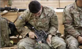  ?? CHRIS SEWARD- ASSOCIATED PRESS ?? A U.S. Army soldier checks his rifle before heading out Saturday at Fort Brag, N.C..