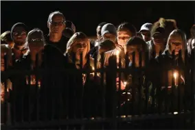  ?? HANS PENNINK ?? FILE - In this Oct. 9, 2018, file photo family members and friends gather for a candleligh­t vigil in Amsterdam, N.Y. The memorial honored 20people who died in Saturday’s fatal limousine crash in Schoharie, N.Y. Political leaders in New York have reached an agreement to pass new limousine safety bills inspired by deadly crashes in 2015and 2018, officials said Tuesday, Jan. 14, 2020.