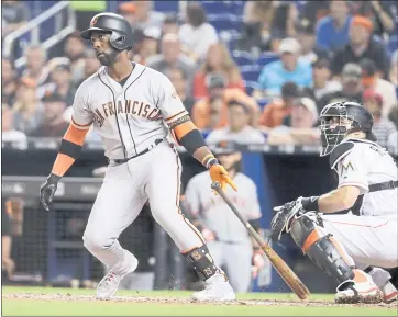  ?? LYNNE SLADKY – THE ASSOCIATED PRESS ?? The Giants’ Andrew McCutchen watches after hitting a RBI double to score Gorkys Hernandez during the fifth inning of Monday’s game against Miami. McCutchen had two hits in the Giants’ 7-5 loss.