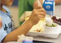  ?? RICARDO RAMIREZ BUXEDA/ORLANDO SENTINEL ?? Kindergart­ners have lunch during the first day of school in Seminole County at Layer Elementary in Winter Springs in 2011. Seminole County will increase school meal prices for the 2022-23 school year because of rising food, labor and supply costs.