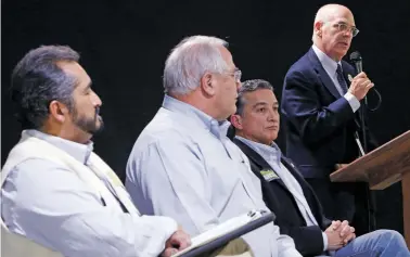  ?? LUIS SÁNCHEZ SATURNO/THE NEW MEXICAN ?? From left, Ronald Trujillo, Peter Ives and Joseph Maestas listen to Alan Webber speak Friday during a mayoral and council candidate forum at the Fraternal Order of Police.